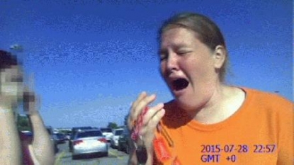 Body cam captures reaction of woman who left child in auto