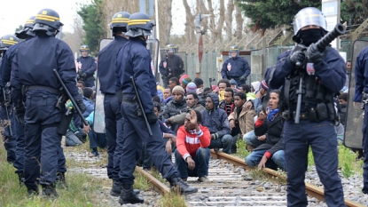 French police spray chemical irritant on migrants trying to storm tunnel