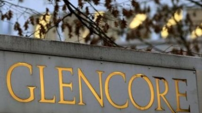 Glencore profit cut in half