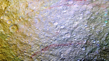 Mysterious, Graffiti-like Red Streaks Spotted on Saturns Battered Moon, Tethys