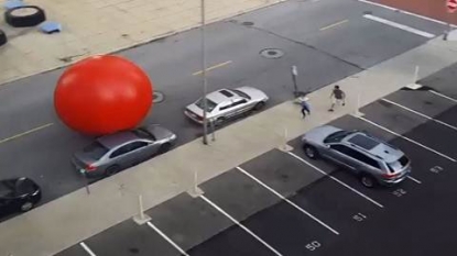 Security scrambles to stop giant red ball rolling from Toledo art installation