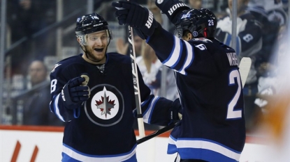 Byfuglien scores late as Jets beat Flames 3-1