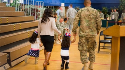 Little girl interrupts homecoming ceremony to hug military father