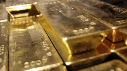 Gold slips to near six-year low