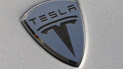 Tesla Loss Widens, Narrows Outlook; Shares Still Gain