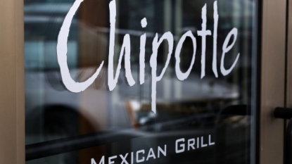 Students fall in after having food at a Chipotle outlet in Boston