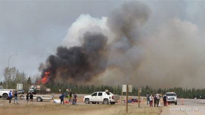 Canada wildfire growing as weather heats up, escape convoy underway