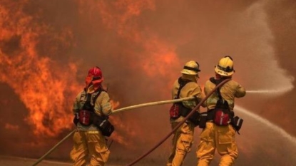 Erratic winds fan fire near Los Angeles