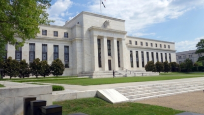 Fed sees less risk, rules out rate rise