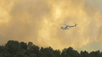 More than 2 dozen large wildfires burn in Western states