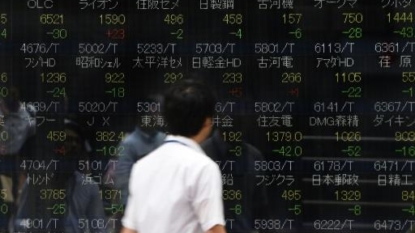 Asia stocks edge up, dollar dips as markets await Fed clues