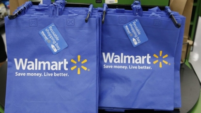 Wal-Mart draws more shoppers, raises fiscal-year outlook