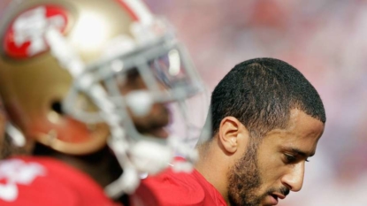 49ers quarterback Colin Kaepernick sits during national anthem