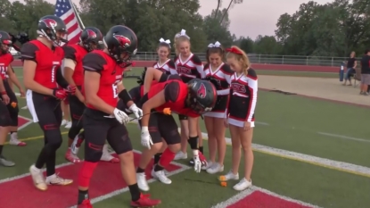 Football players honor cheerleader diagnosed with Leukemia