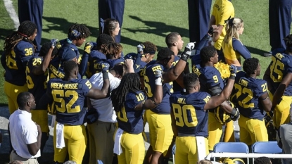 Michigan State players raise fists during national anthem