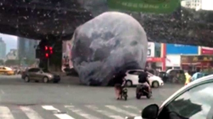 Moon balloon rolls rogue through streets of China