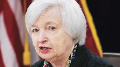 Divided Fed holds interest rates steady but notes improving economy